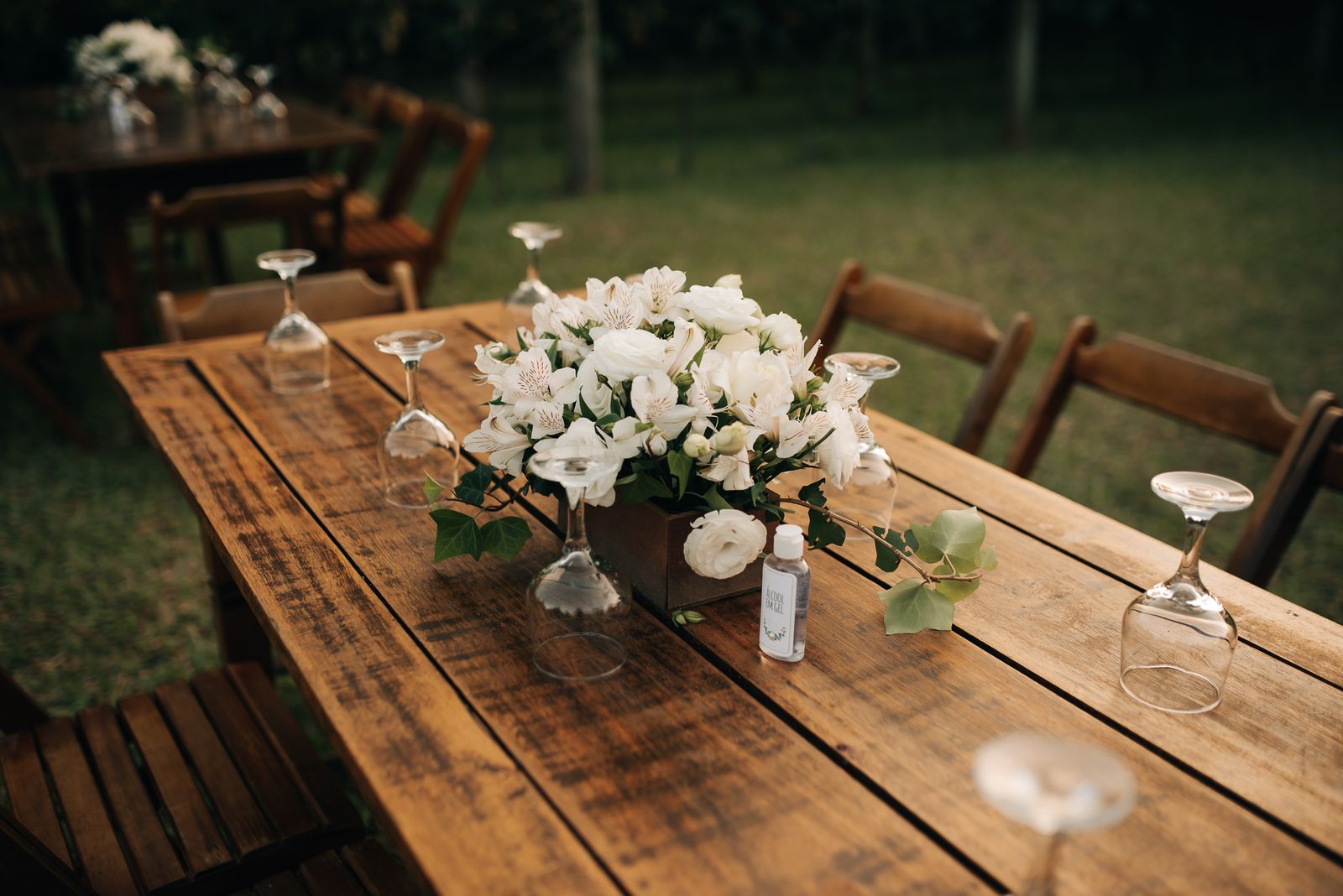 Beautifully arranged wedding reception table with flowers outdoors.