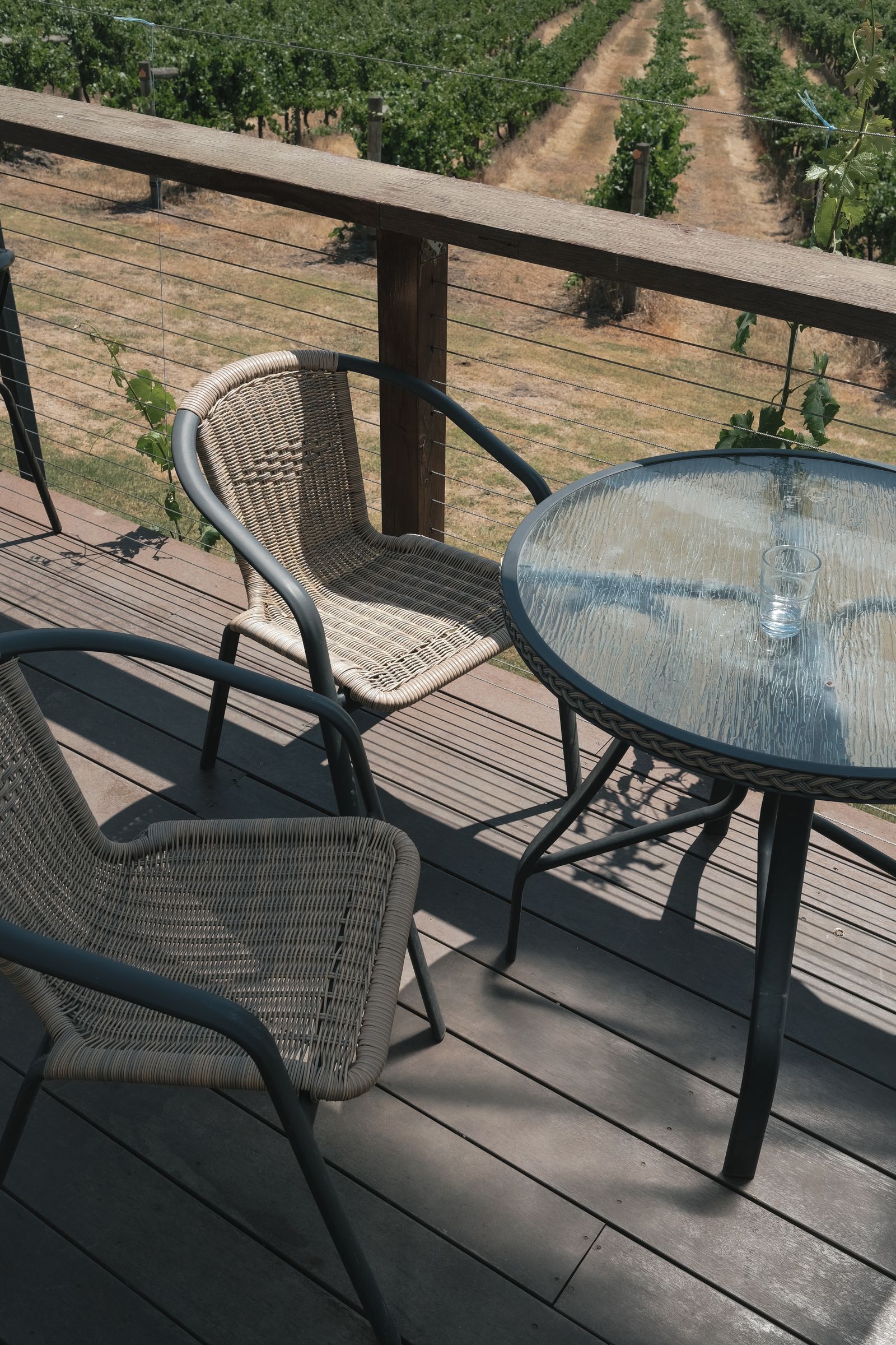 Cozy vineyard patio with two empty chairs and a clear table in Gruyere, VIC.